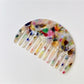 Camerow half round hair comb placed next to hair strands for scale