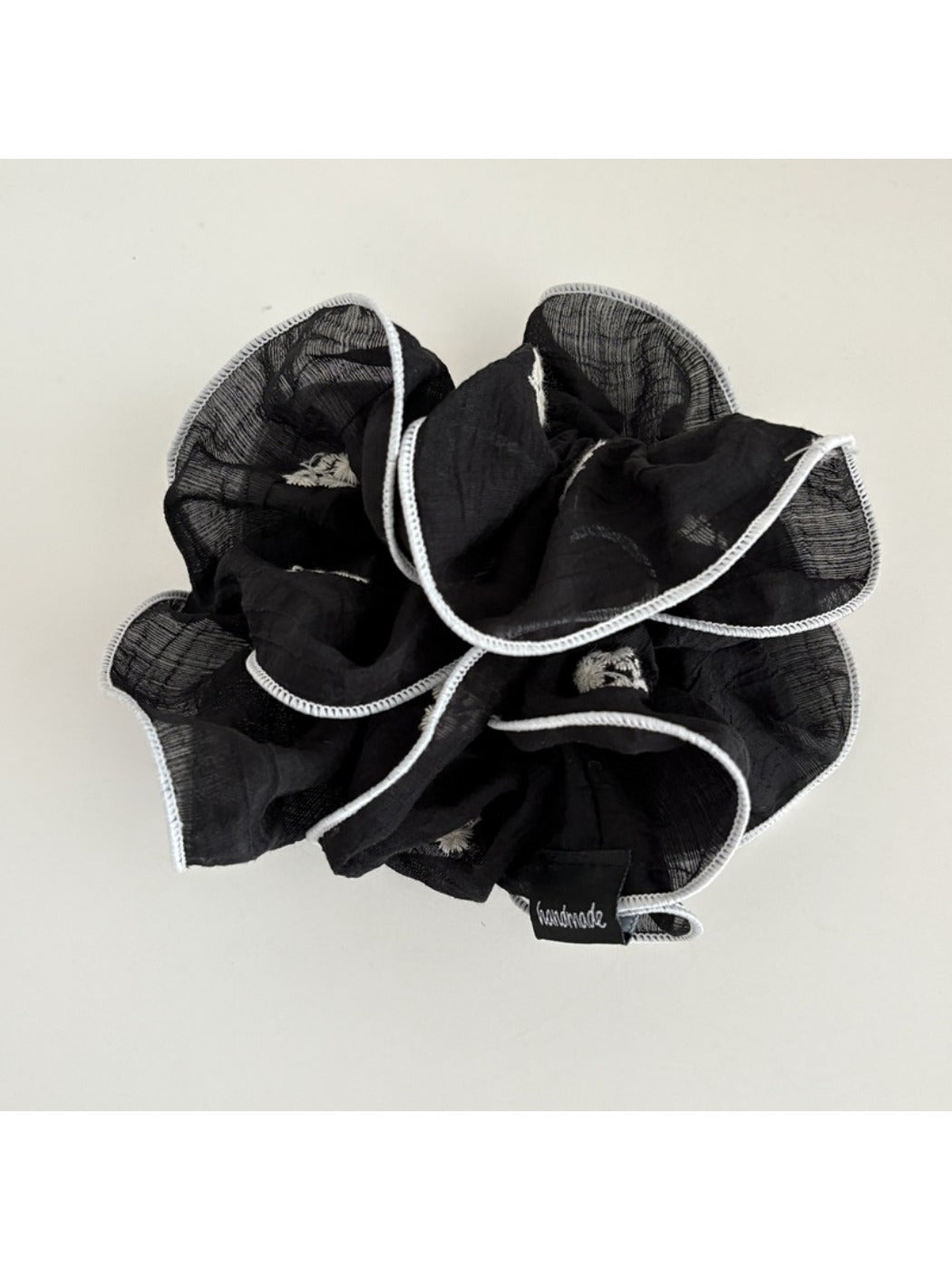 Elegant scrunchie wrapped around a ponytail in a casual hairstyle
