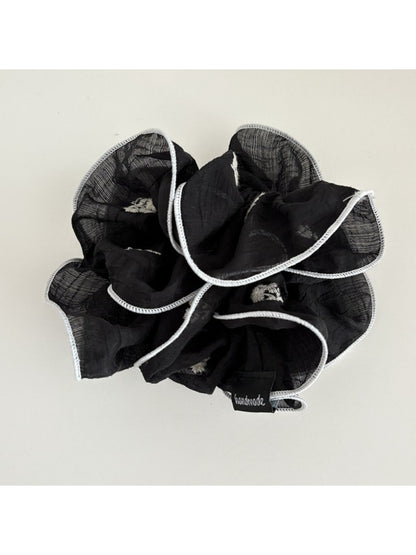 Elegant scrunchie wrapped around a ponytail in a casual hairstyle