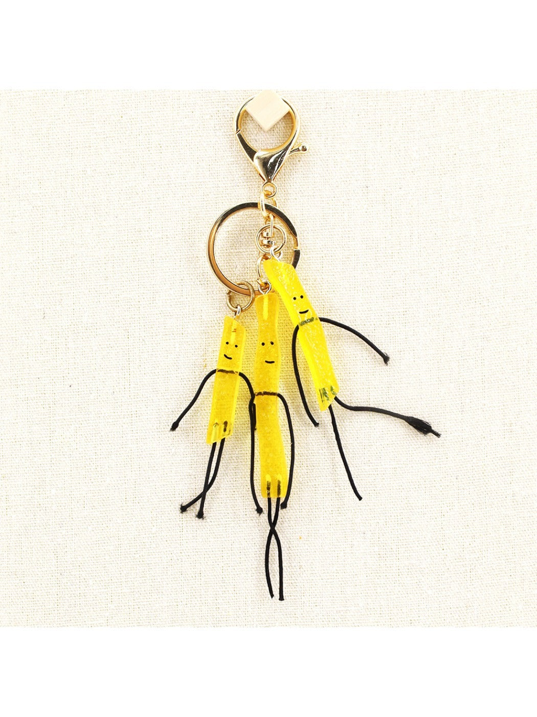 Miniature French fries keychain with yellow fries in a red container