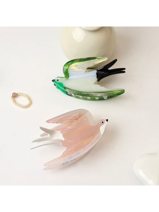 Beau cute little bird shape claw clip in pastel pink on white background