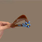 Beau minimalist triangular hair claw clip in matte black, shown closed