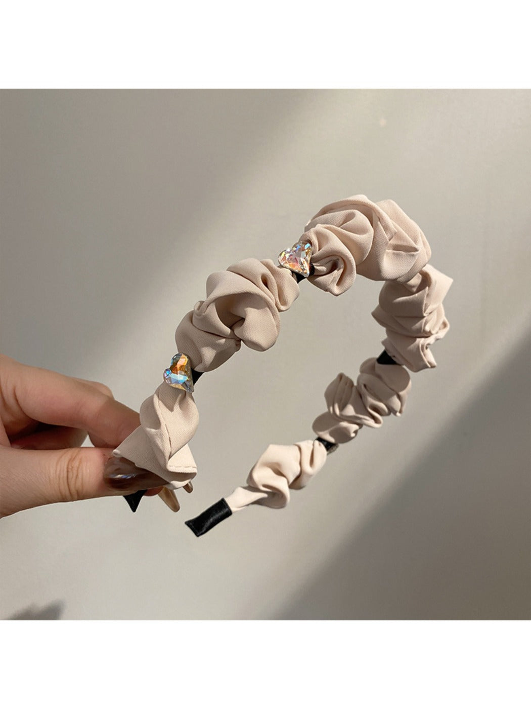 Top view of rhinestone headband showing symmetrical heart shape and shine