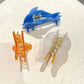 Beau claw clip open to display metal spring mechanism and teeth