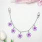Flower pendant bag charm displayed on a wooden surface