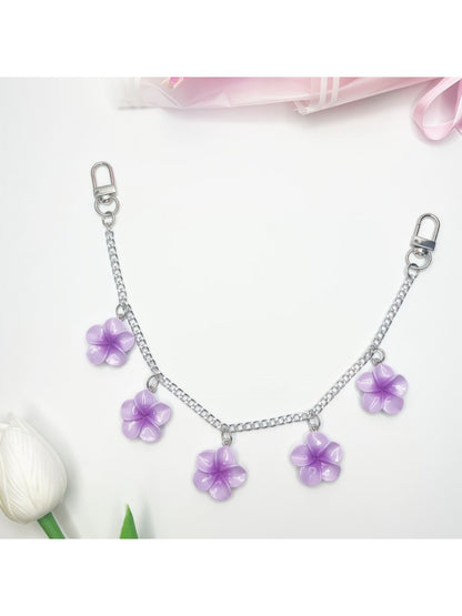 Flower pendant bag charm displayed on a wooden surface