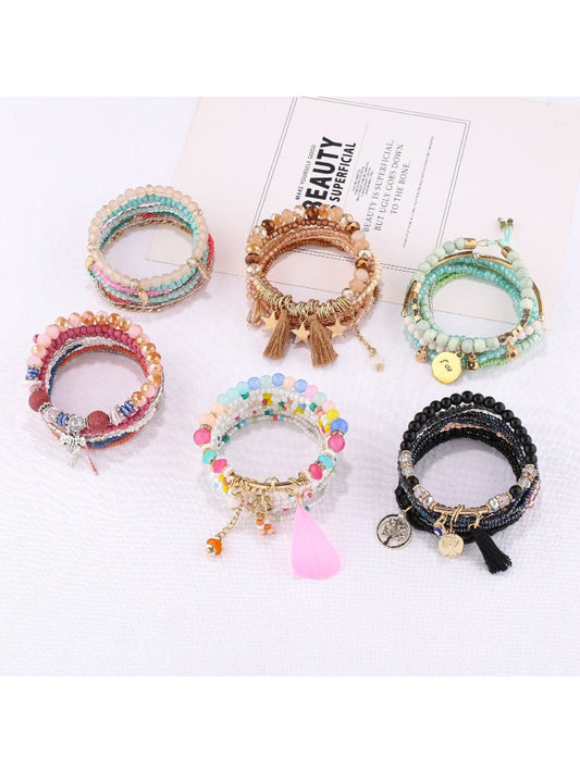 Close-up of Lovra trendy stackable beaded bracelets in various colors on a white background