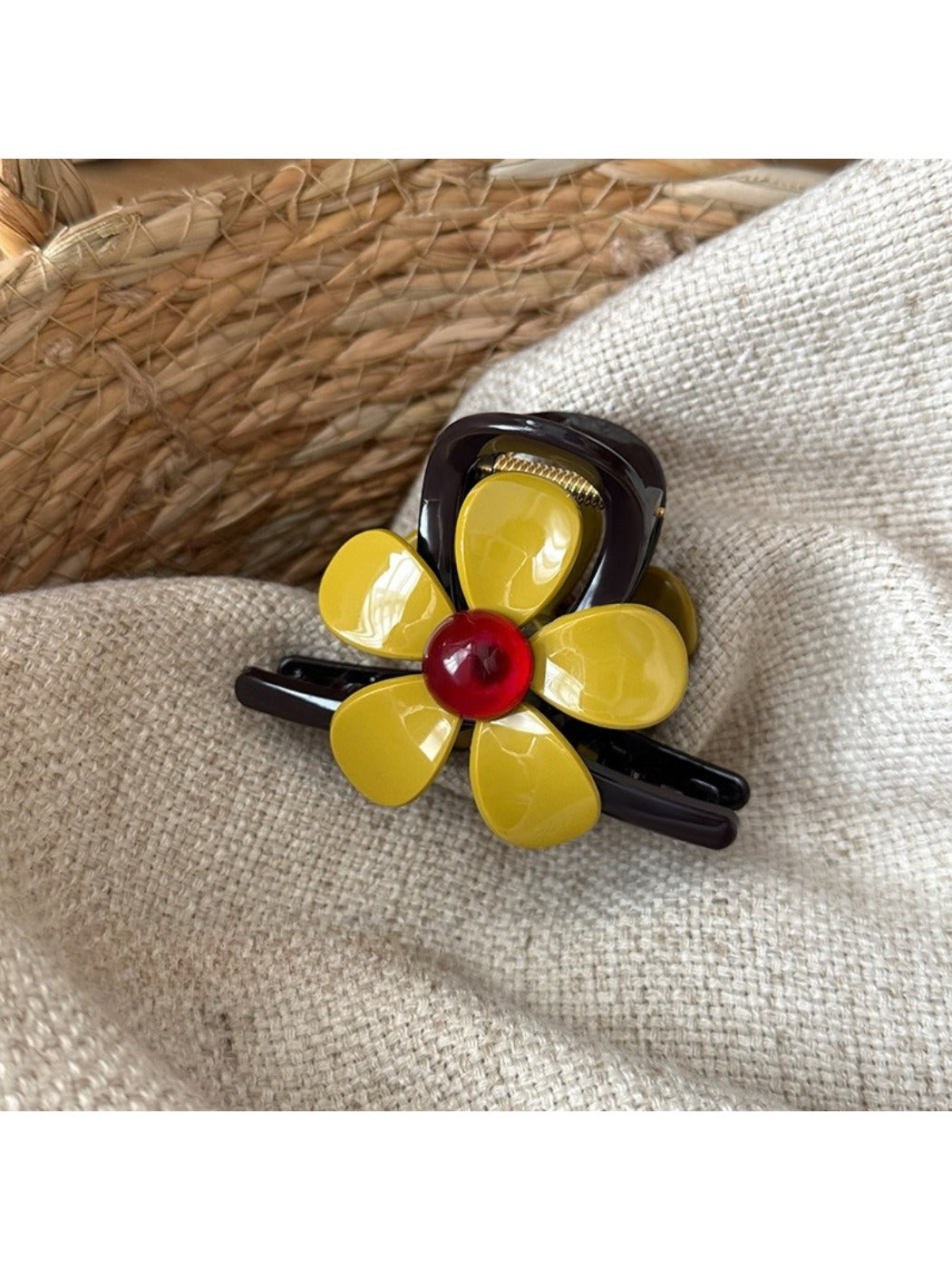 Beau flower-shaped claw clip displayed on a wooden surface