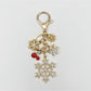 Hand holding delicate snowflake pendant keychain with silver keyring