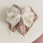 Beau tiny floral lace bow claw clip displayed on a model's hair