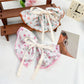 Beau Chic Sweet Bow Hair Clip styled in model's blonde hair against neutral background