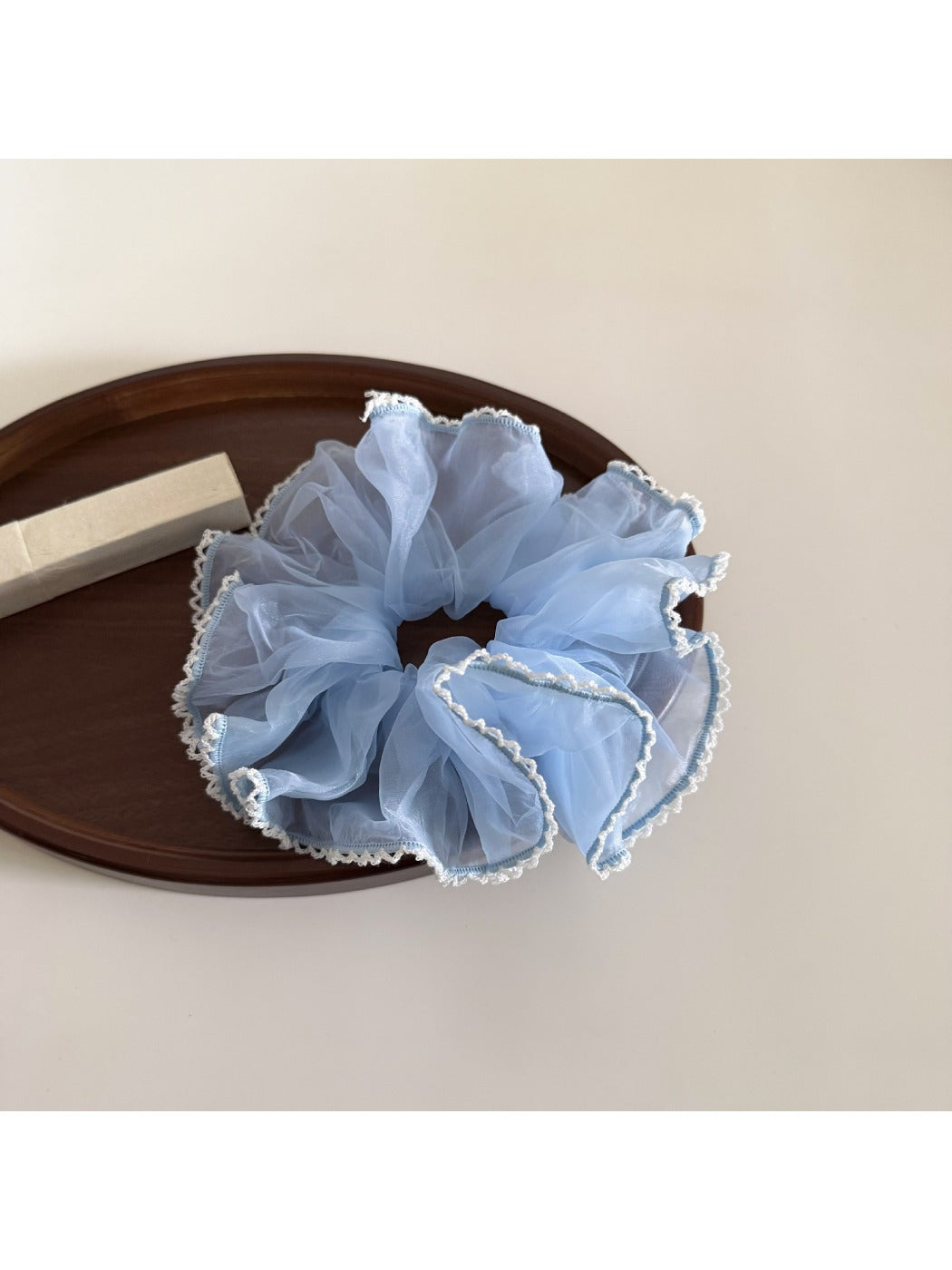 Multiple Gifty ruffled scrunchies in different solid colors displayed together