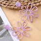 Earedge flower shaped openwork drop earrings with light reflecting on metal surface