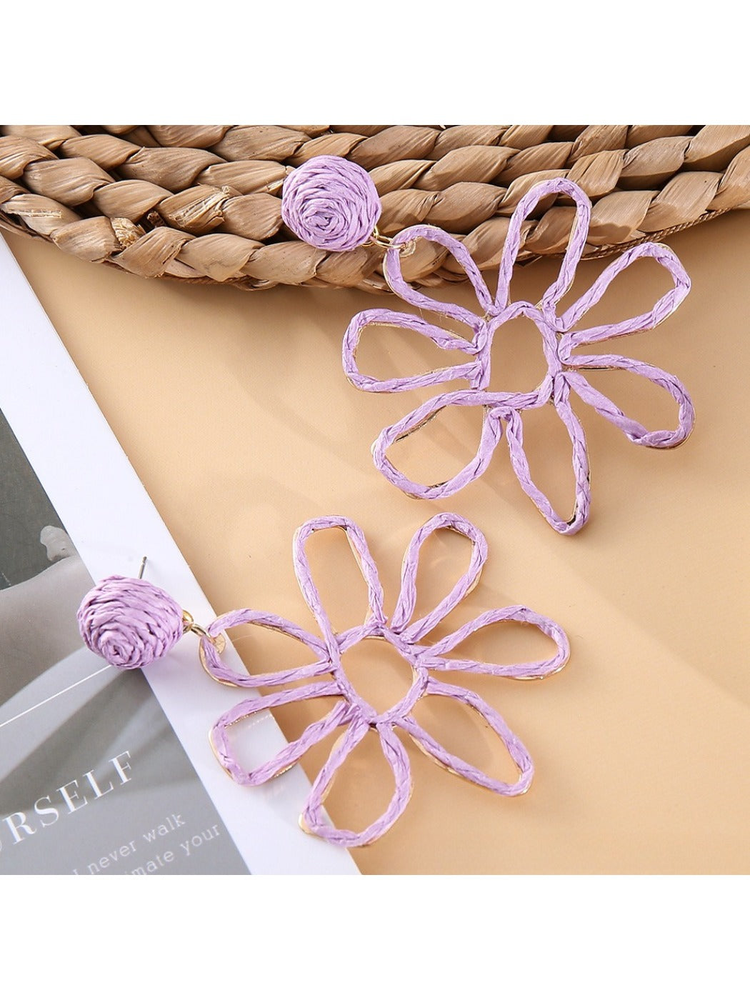 Earedge flower shaped openwork drop earrings with light reflecting on metal surface