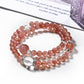 Lovra pink crystal beaded bracelet displayed on a wooden surface with soft lighting