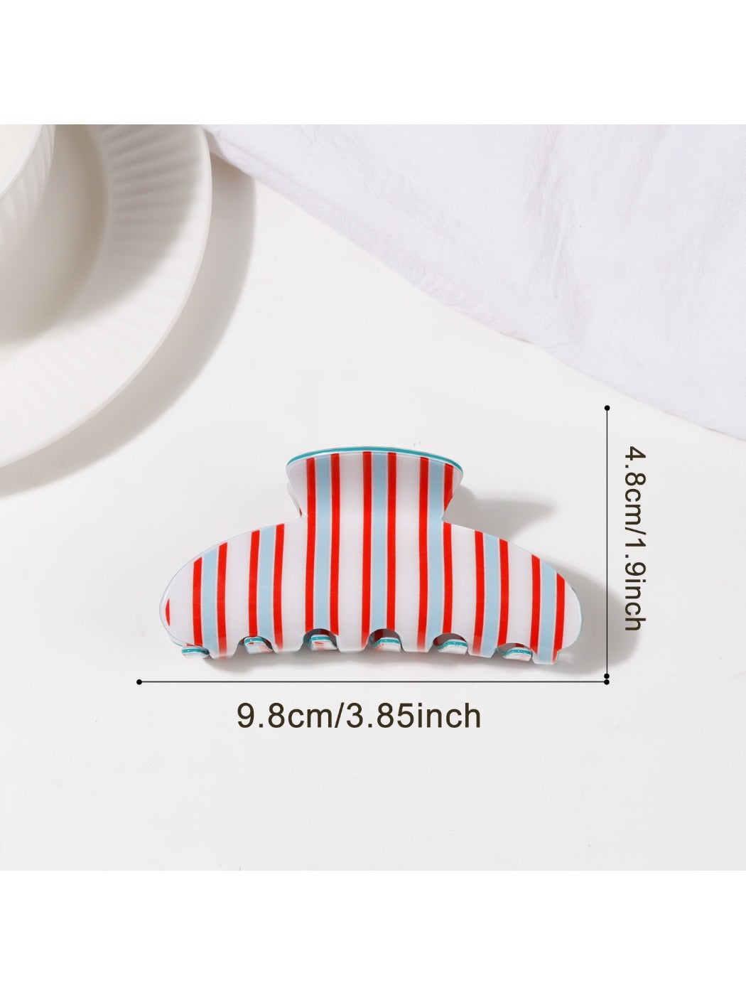Beau striped half moon claw clip angled to show thickness and colors