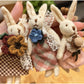 Rabbit charm keychain hanging from a set of keys on a wooden surface