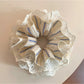 Chic striped lace scrunchie in soft pastel colors on a white background