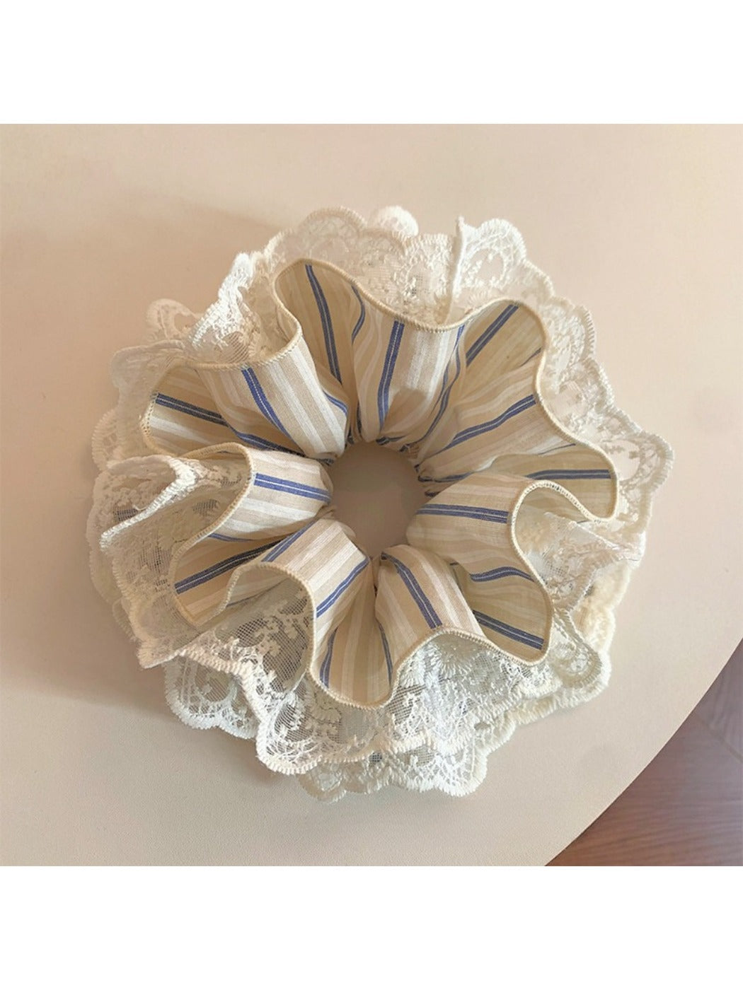 Chic striped lace scrunchie in soft pastel colors on a white background