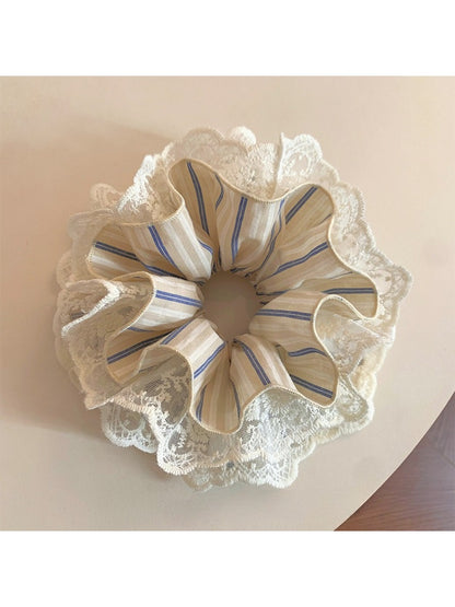Chic striped lace scrunchie in soft pastel colors on a white background