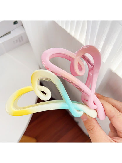 Beau heart shaped claw clip held in hand displaying size and grip