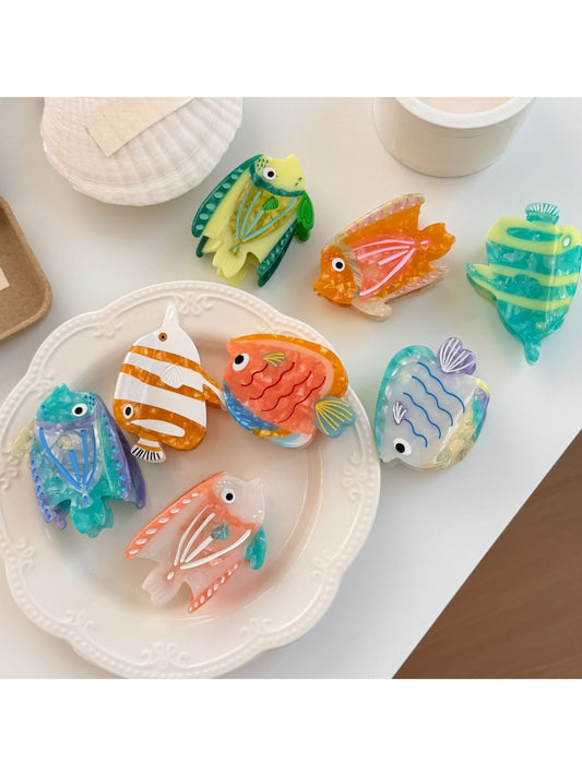 Beau colorful fish shaped claw clip with blue and orange details on white background