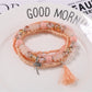 Lovra bracelet styled with casual outfit featuring colorful beads and tassels