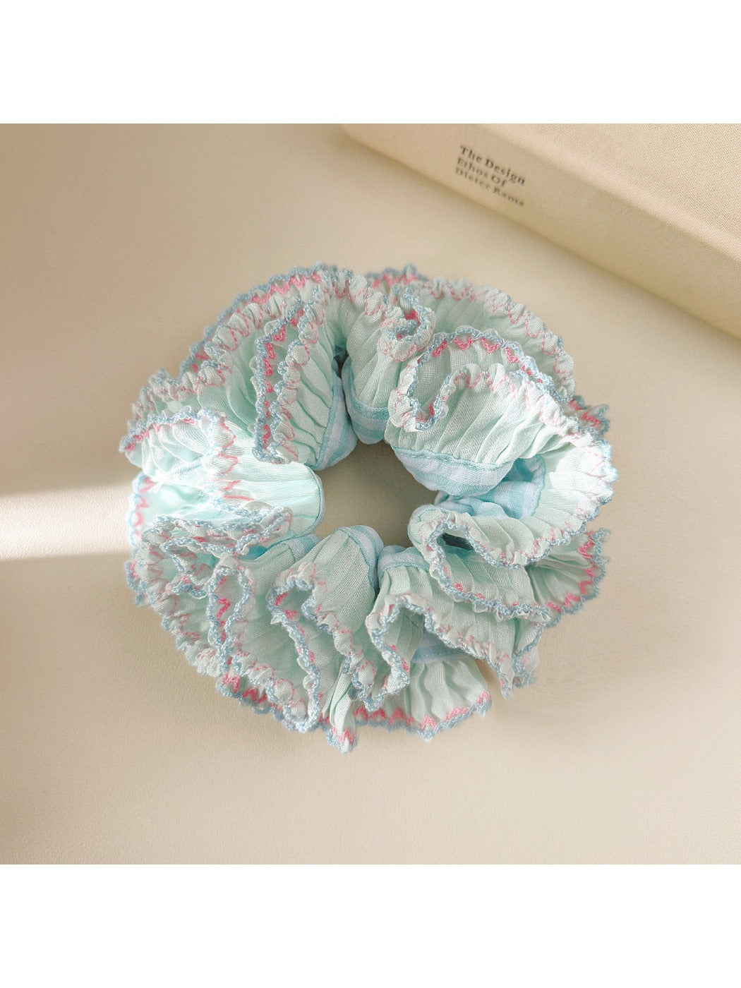 Blue double layer ruffle scrunchie displayed on a white background