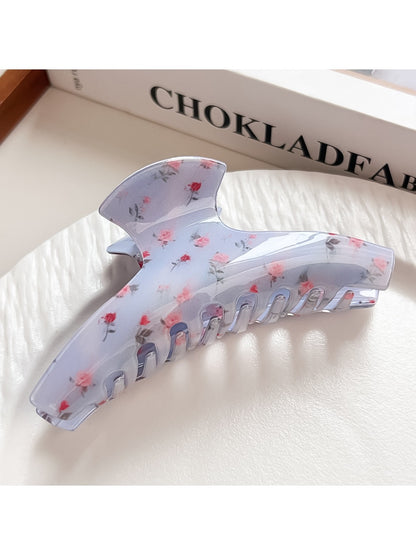 Beau shark claw clip placed on wooden surface highlighting design