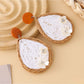 Top view of Earedge raffia woven teardrop earrings highlighting the woven pattern