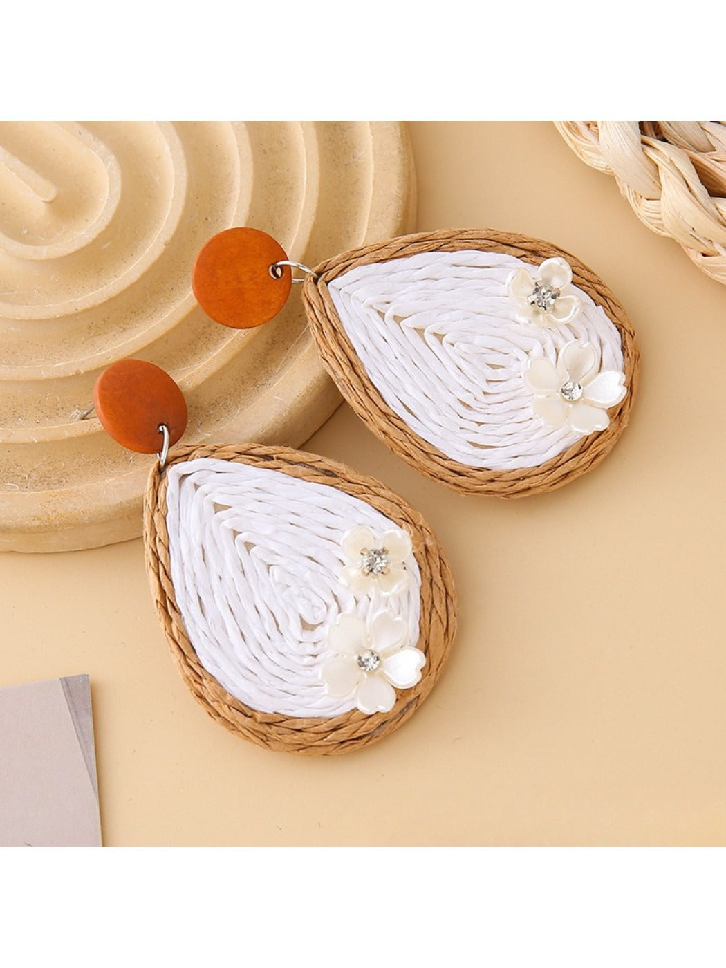 Top view of Earedge raffia woven teardrop earrings highlighting the woven pattern