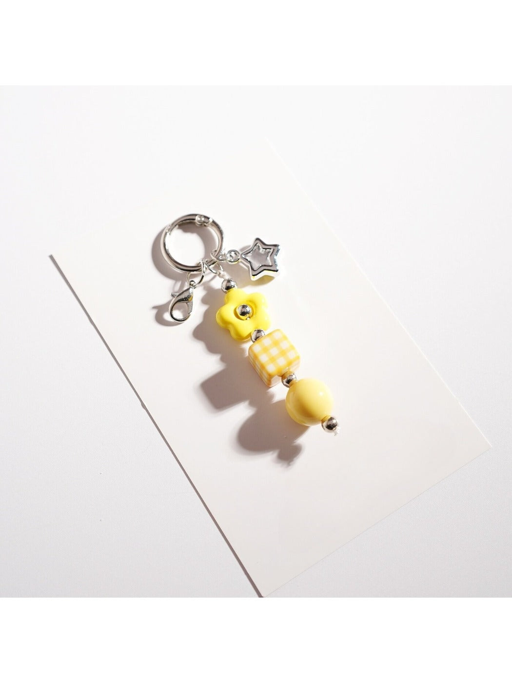 Keypus beaded star keychain hanging from a backpack zipper pull