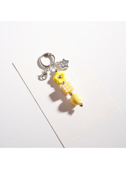 Keypus beaded star keychain hanging from a backpack zipper pull