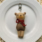Fabric bear cub keychain showing back side with stitched details