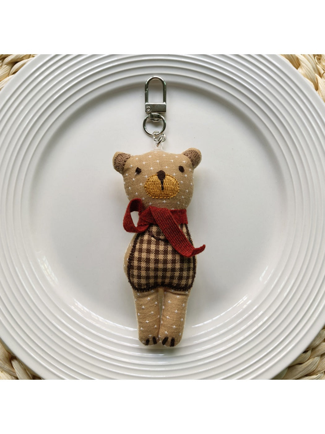 Fabric bear cub keychain showing back side with stitched details