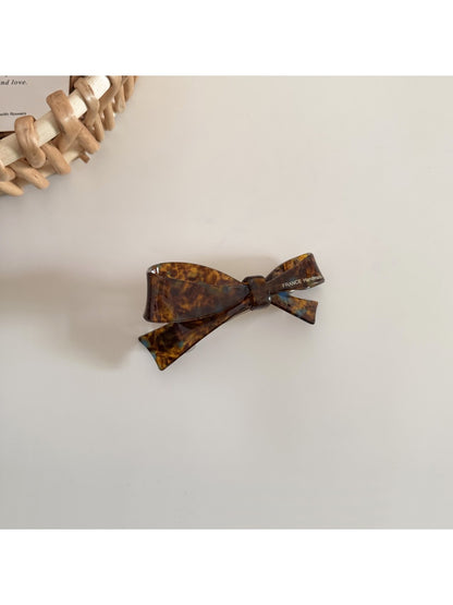 Beau hair clip held in hand showing size and shape