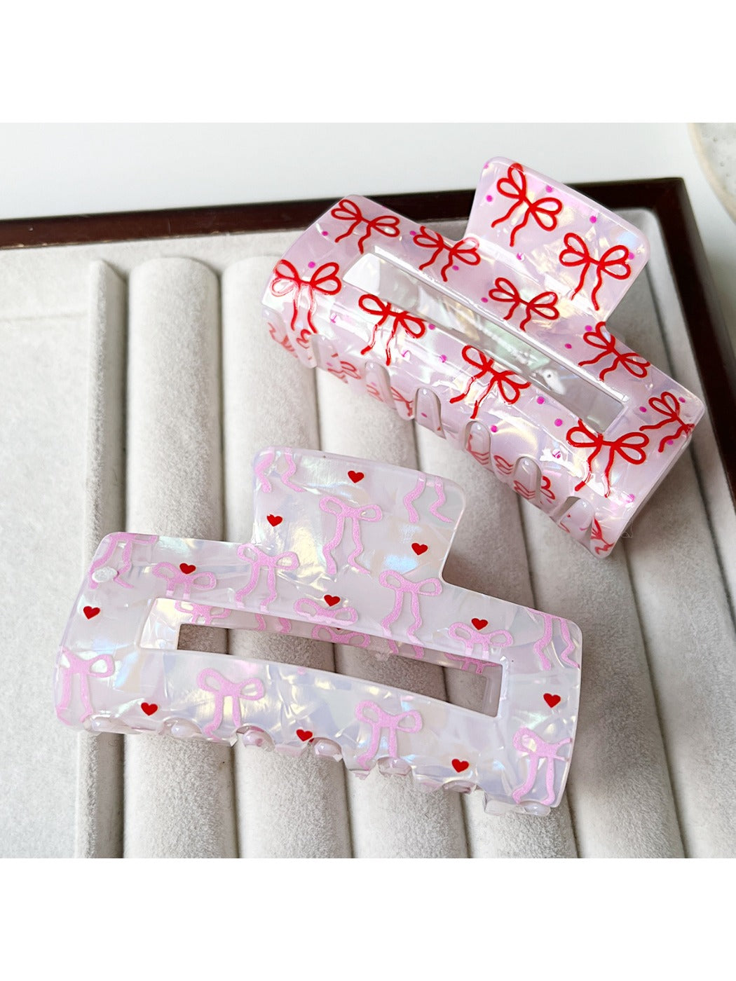 Close-up of black bow print on clear acetate claw clip