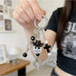 Side view of the minimalist ghost keychain highlighting its slim profile