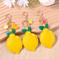 Yellow lemon-shaped keychain with green leaf detail on a silver keyring