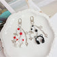 Close-up of the headphone pendant keychain showing detailed ear cup design