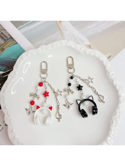 Close-up of the headphone pendant keychain showing detailed ear cup design