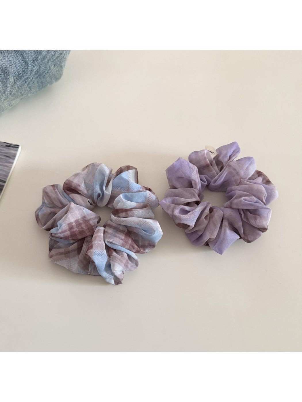 Gifty scrunchie styled on a model's ponytail with checkered pattern