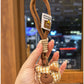 Side view of the bear charm keychain showing its rounded ears and stitched details