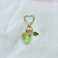 Side view of Keypus strawberry charm keychain highlighting the metal ring