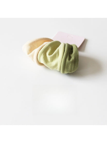 Solid color hair ties arranged in a circle highlighting their uniform size