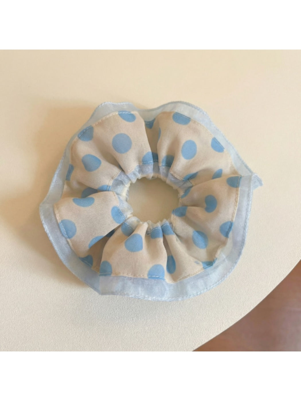 Gifty scrunchie worn in a ponytail with visible black and white polka dot pattern