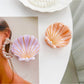 Beau hair claw clip held in hand displaying size and shell design