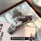 Beau acetate claw clip open, showing the inner teeth and clasp details