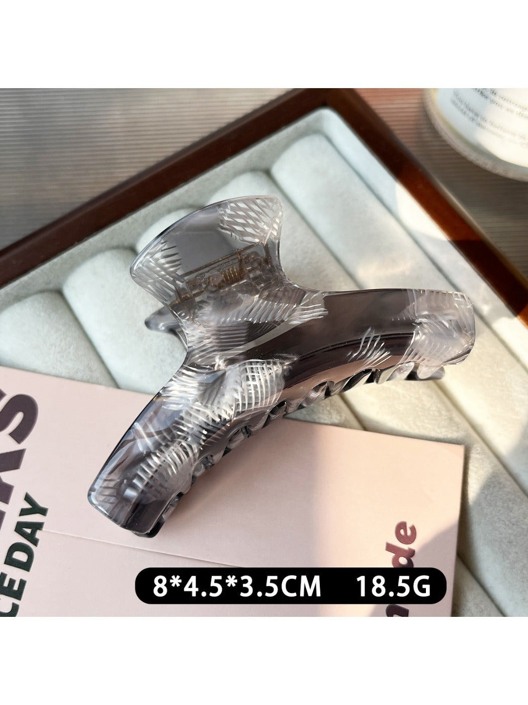 Beau acetate claw clip open, showing the inner teeth and clasp details
