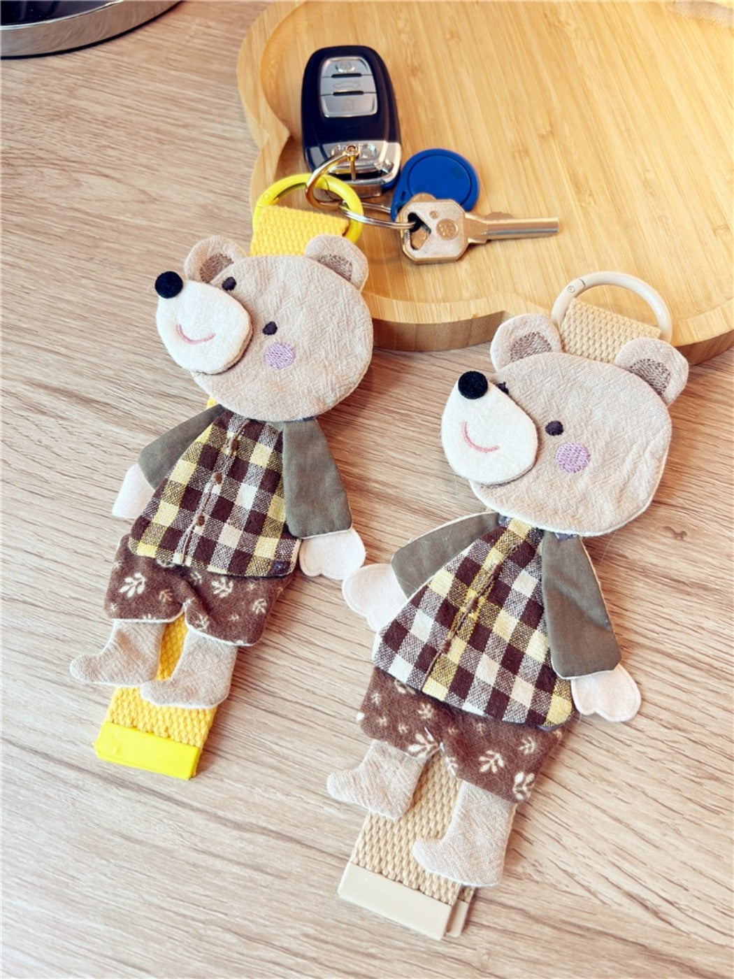 Back view of the patchwork bear keychain displaying multicolored fabric pieces